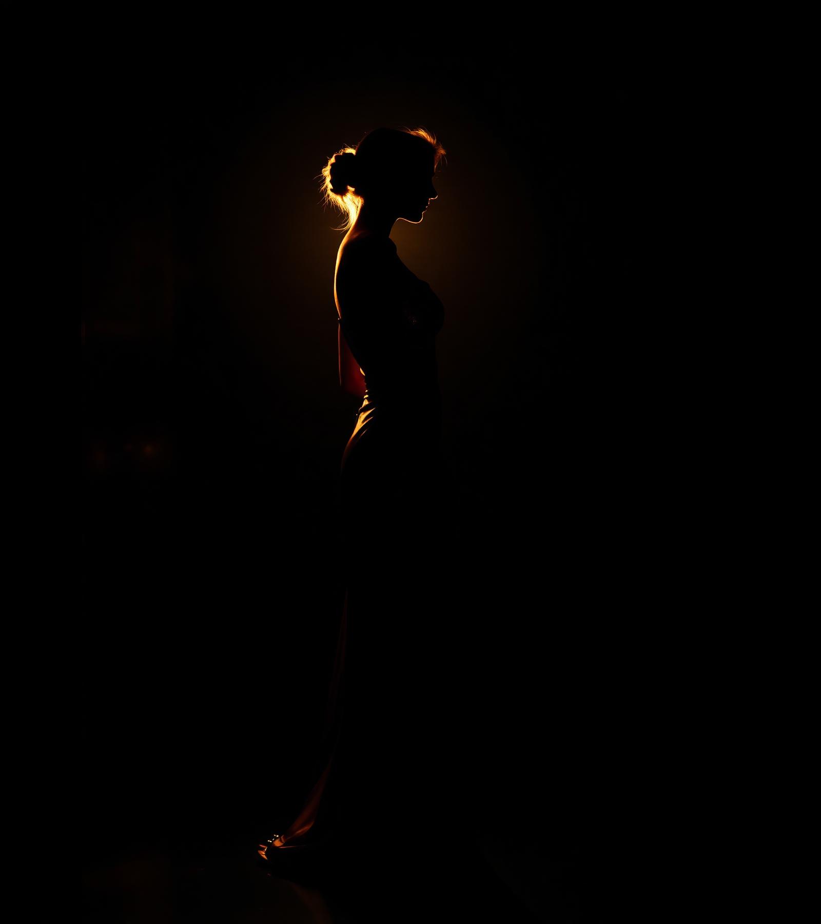 Editorial silhouette in golden rim light